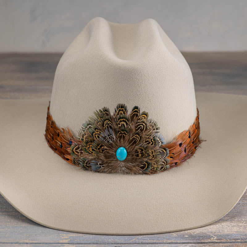 Beige cowboy hat with front feather band and turquoise round bead detail.