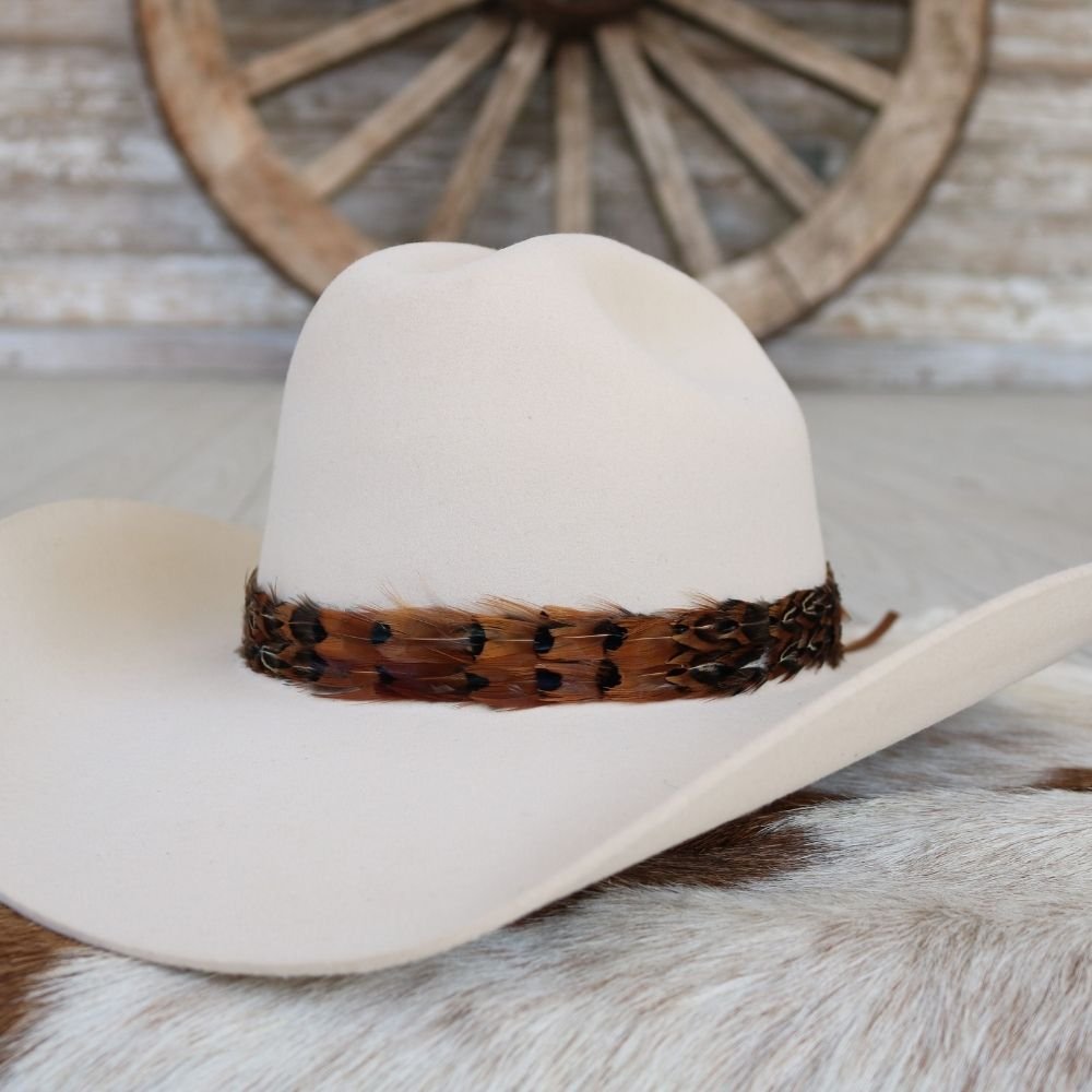 Light felt cowboy hat with rust-toned leopard feather band