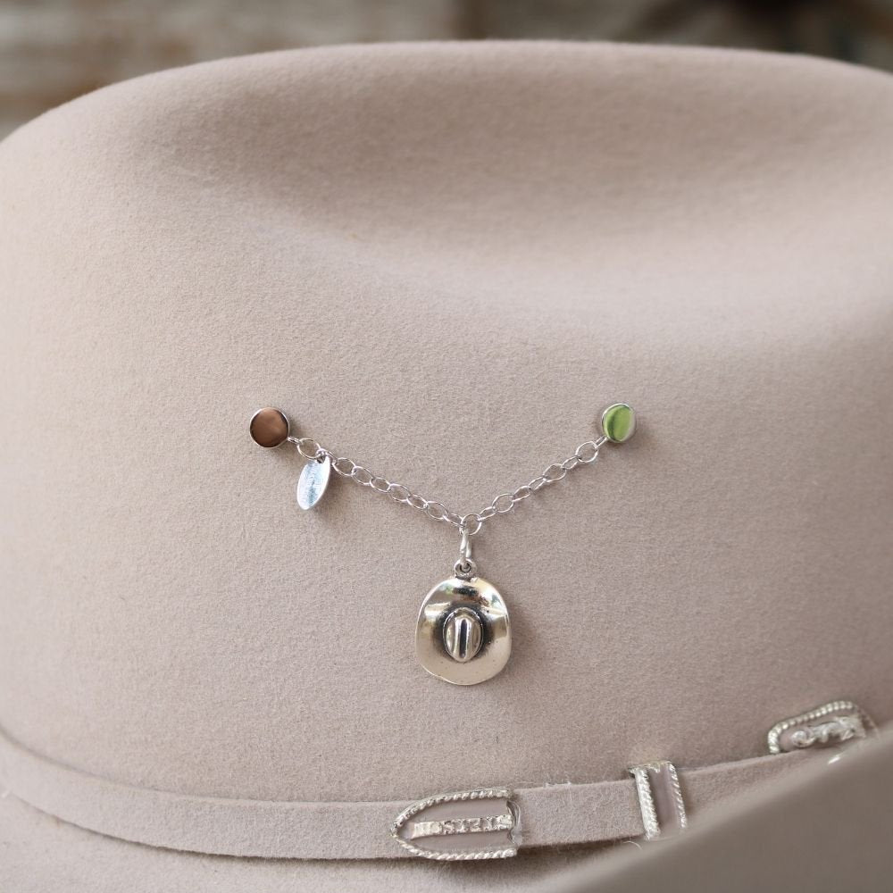 Sterling silver cowboy hat charm on necklace chain with small dangling accents.