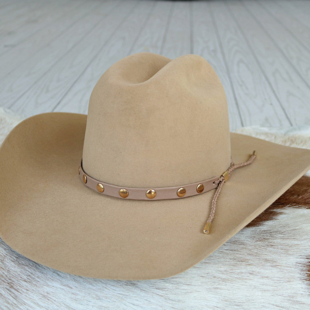 Taupe studded goat leather hat band on felt hat, gold eyelet studs and braided cord