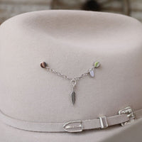 Sterling silver charm necklace with feather pendant and small dangling beads