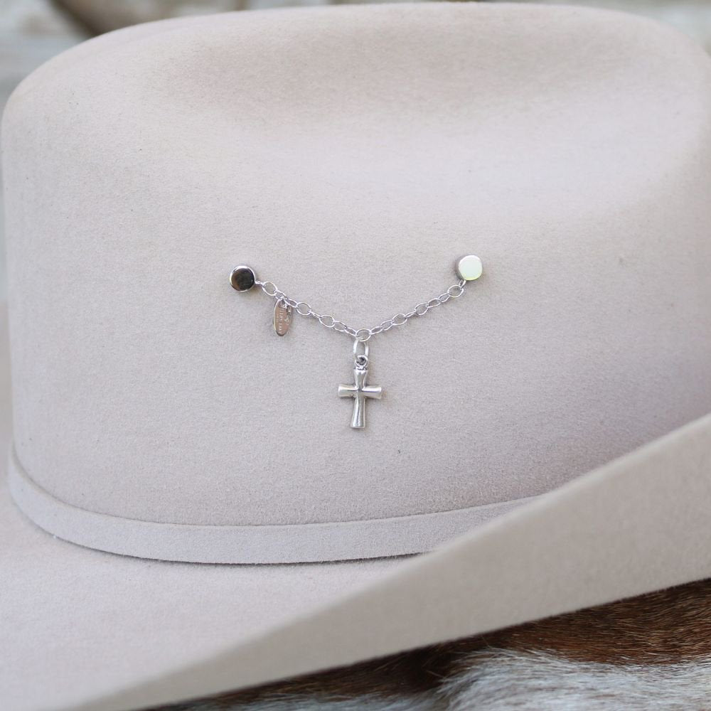 Sterling silver charm necklace with cross pendant and small bead accents on chain.