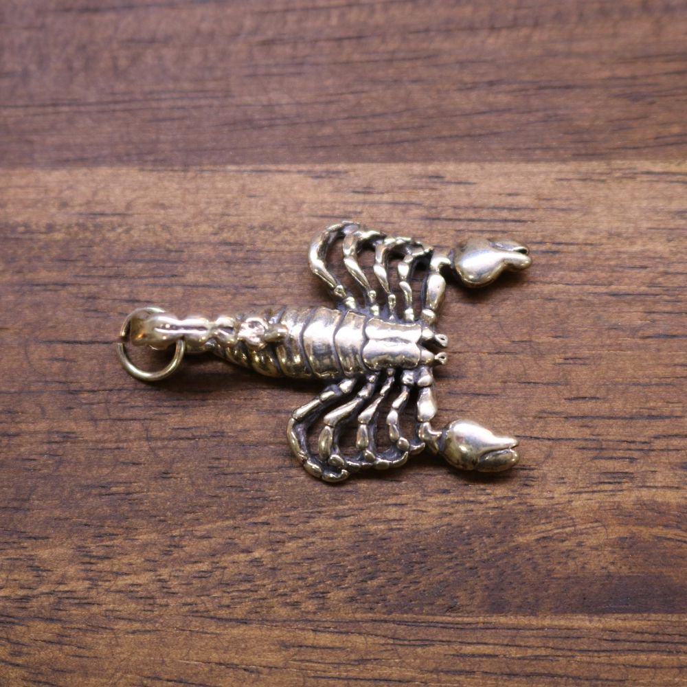 Sterling silver scorpion pendant, side view with ridged tail and attached loop bail