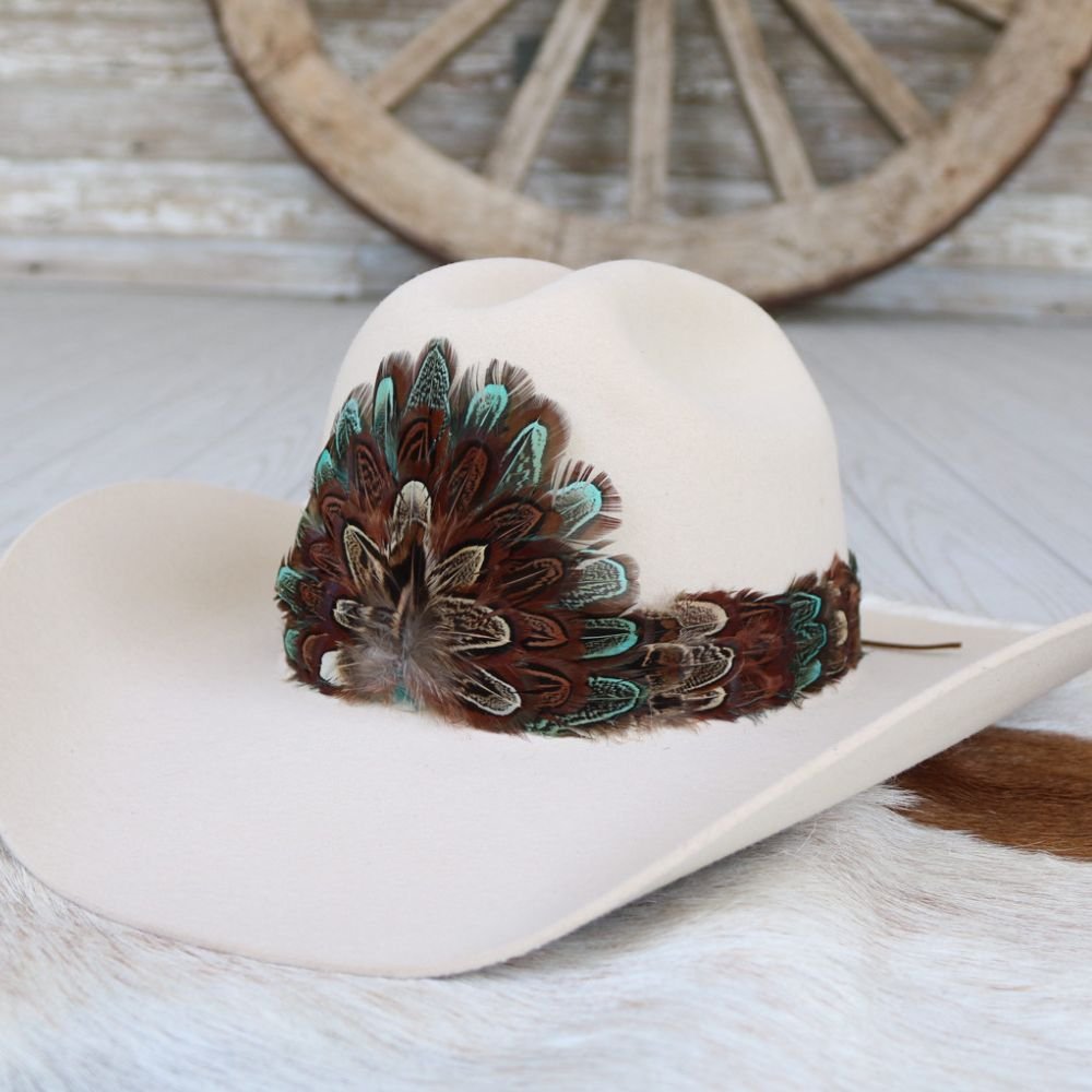 Cream felt cowboy hat with multicolor feather band across the crown