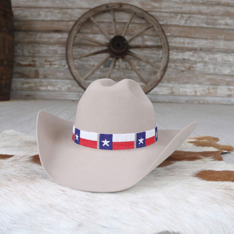 White cowboy hat with Texas flag band featuring blue stars and red stripes