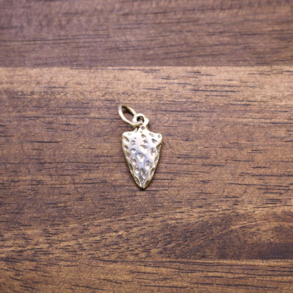 Small sterling silver arrowhead charm with textured face and top loop