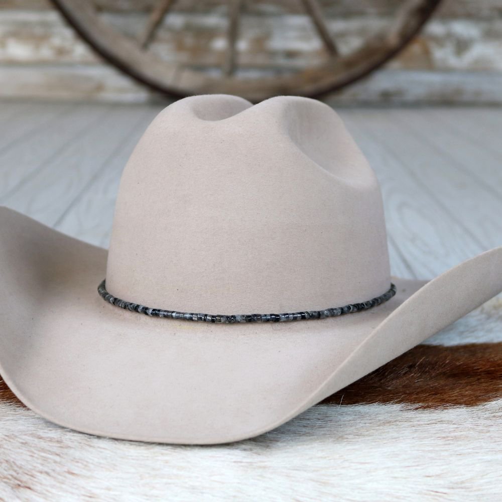 Light gray felt hat with dark beaded stone hat band around brim