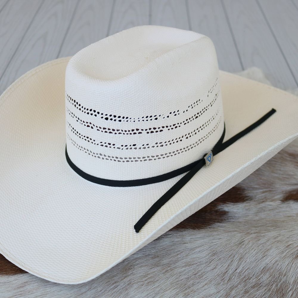 White straw cowboy hat with black band and side tie, wide brim close view