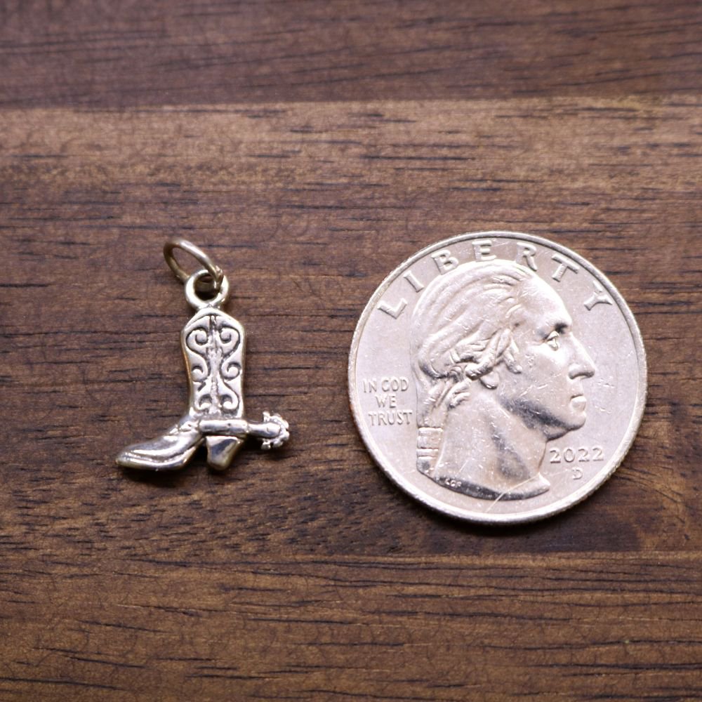 Sterling silver boot charm pendant with loop bail, shown next to coin