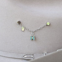 Sterling silver charm bracelet with dangling butterfly charm and small enamel accents