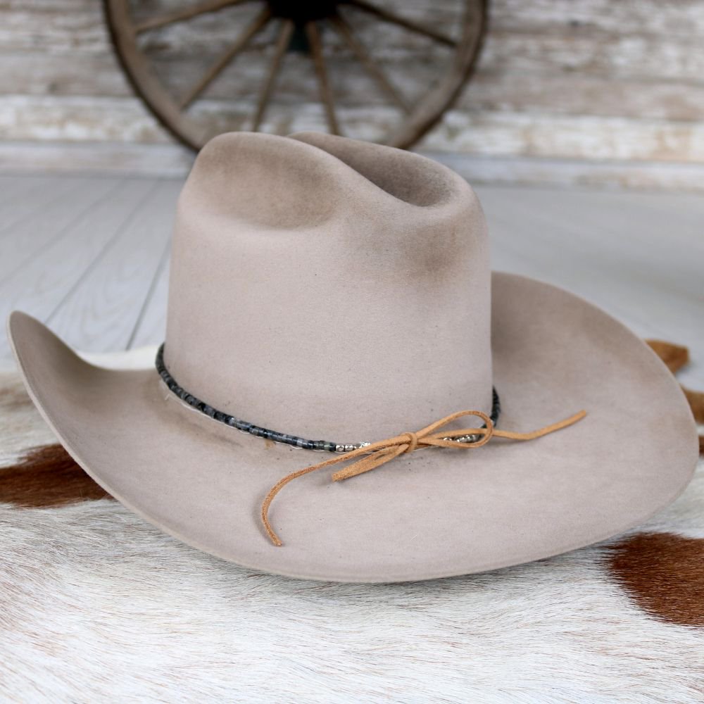 Beige felt hat with dark beaded stone hat band and tan cord tie