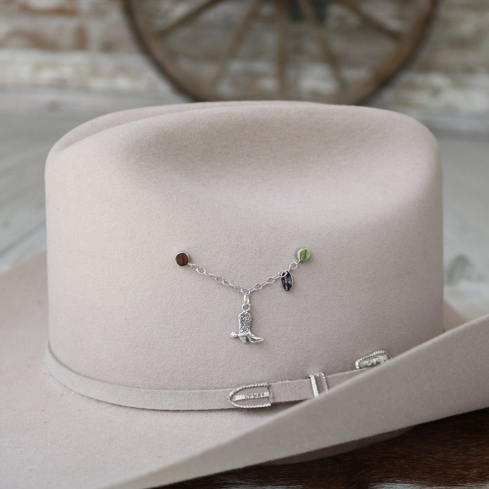 Sterling silver boot charm on charm necklace chain with small green accents on display