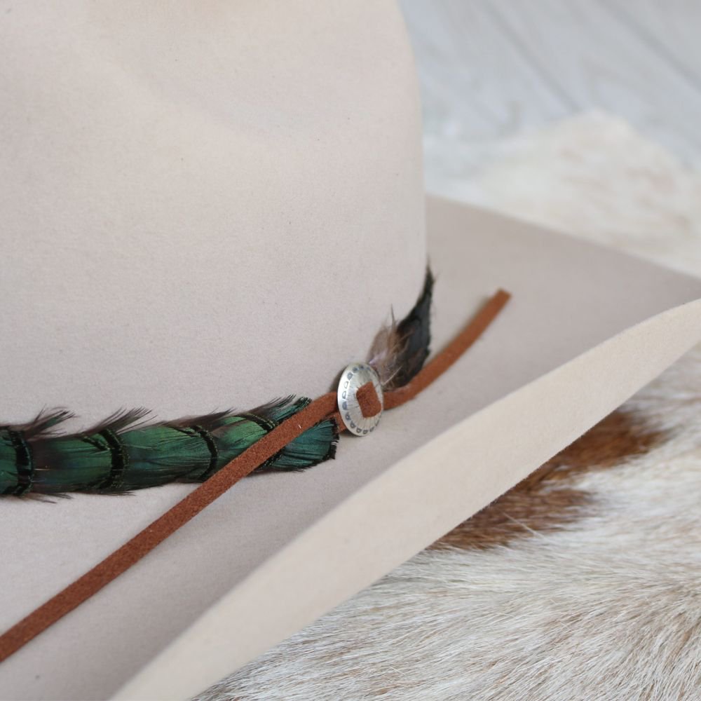Sterling silver slotted concho detail on brown leather strap with feather edge