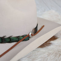 Sterling silver slotted concho detail on brown leather strap with feather edge
