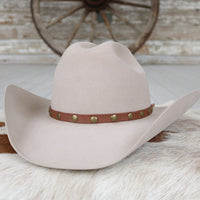 Studded goat-leather hat band in medium brown with round green and gold-tone studs