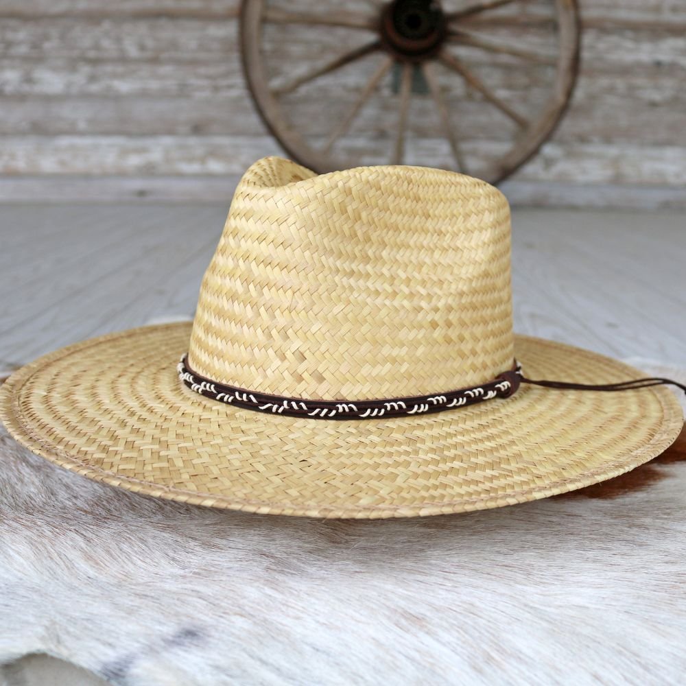 Straw cowboy hat in light tan with dark woven band and wide brim