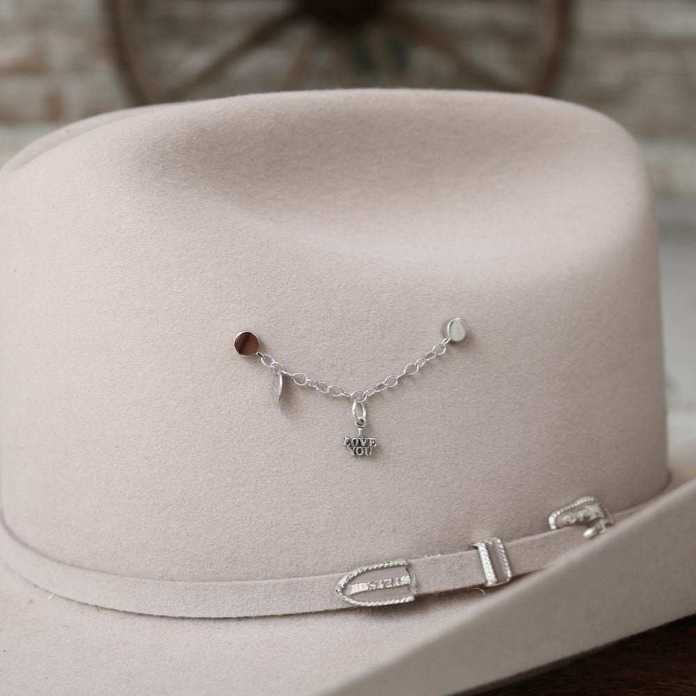Sterling silver LOVE YOU charm bracelet with heart-shaped clasp on display