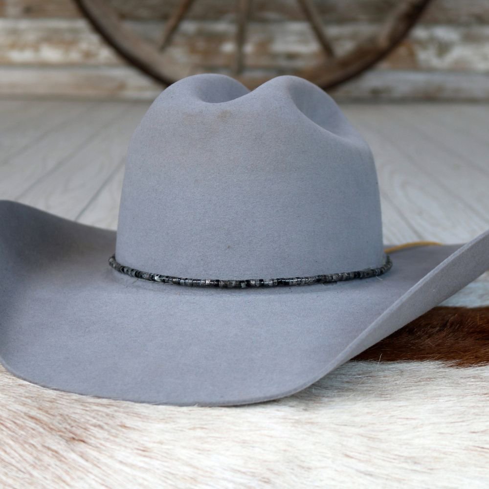 Gray felt hat with dark blue beaded stone band around brim