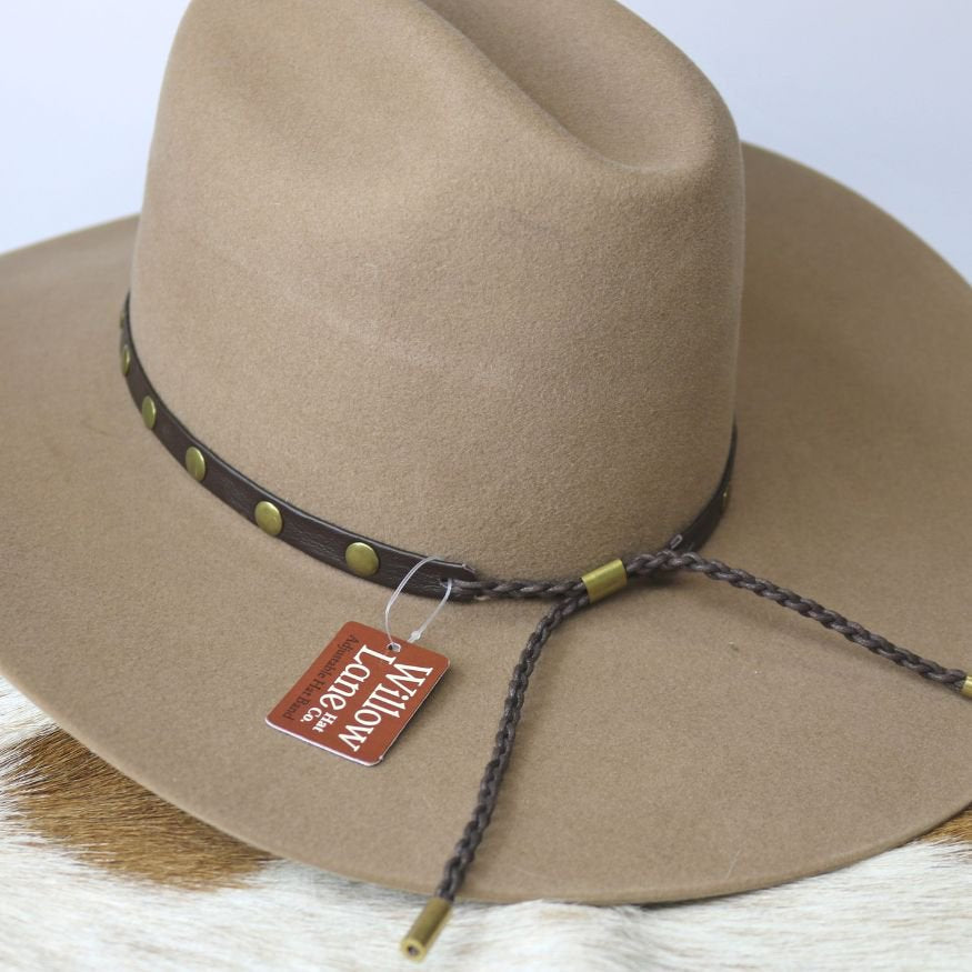Studded goat leather hat band with braided ties and brass-green rivets