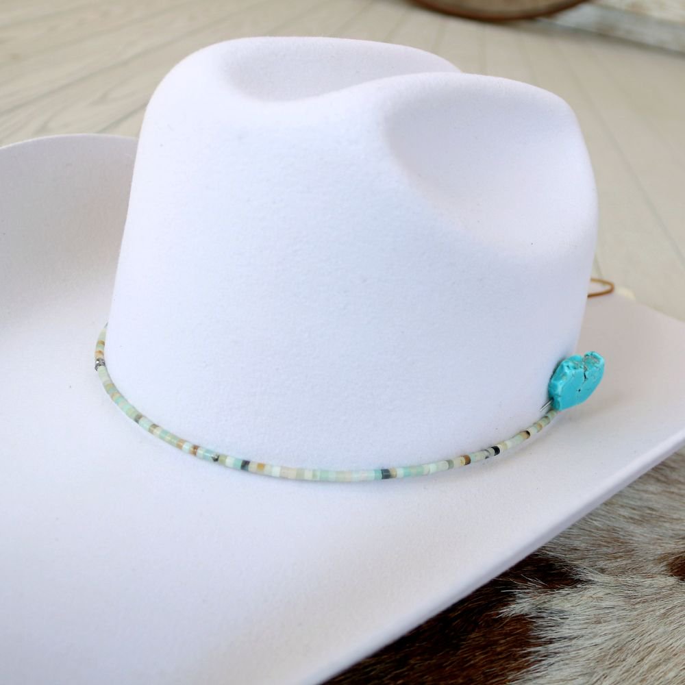 White felt hat with turquoise beaded hat band and small side charm