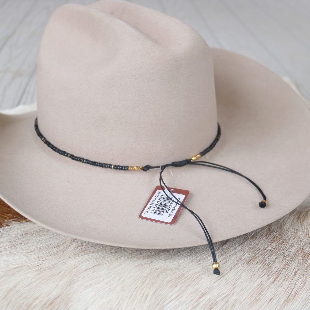Cleo beaded hat band with tag and black adjustable cords on white felt hat
