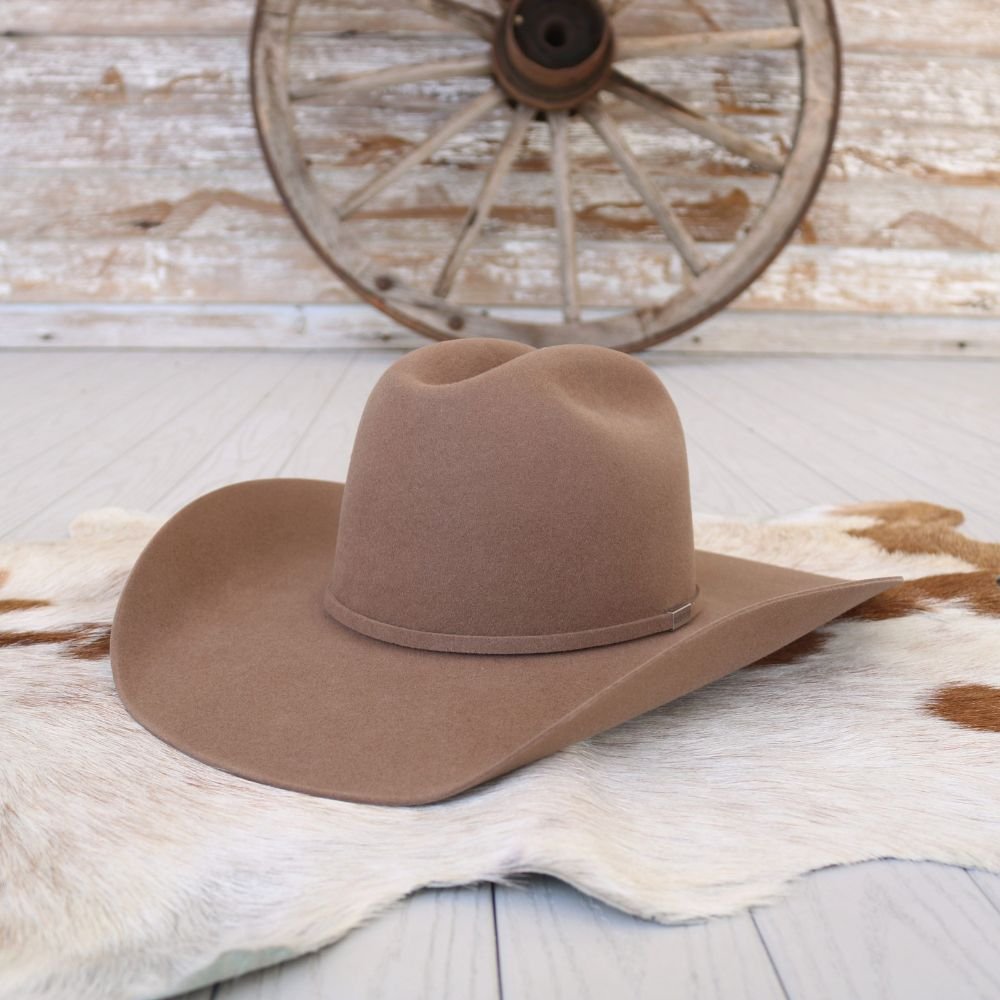 Tan fur felt cowboy hat with curved brim and telescope crown