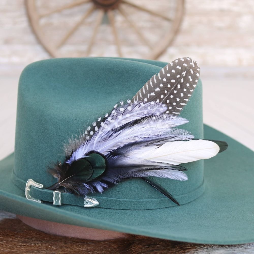 Teal felt hat with blue-and-green feather accent and polka-dot trim band