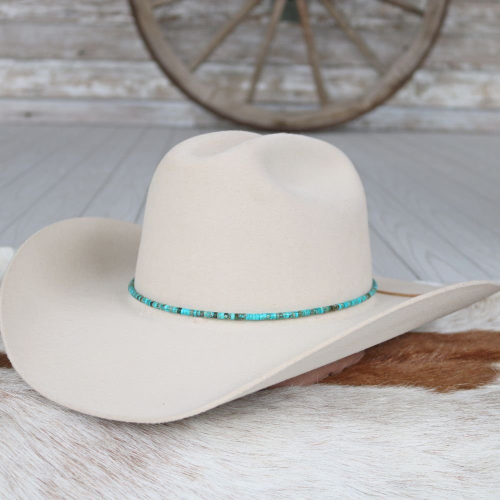 Light beige cowboy hat with turquoise stone beaded band around the crown