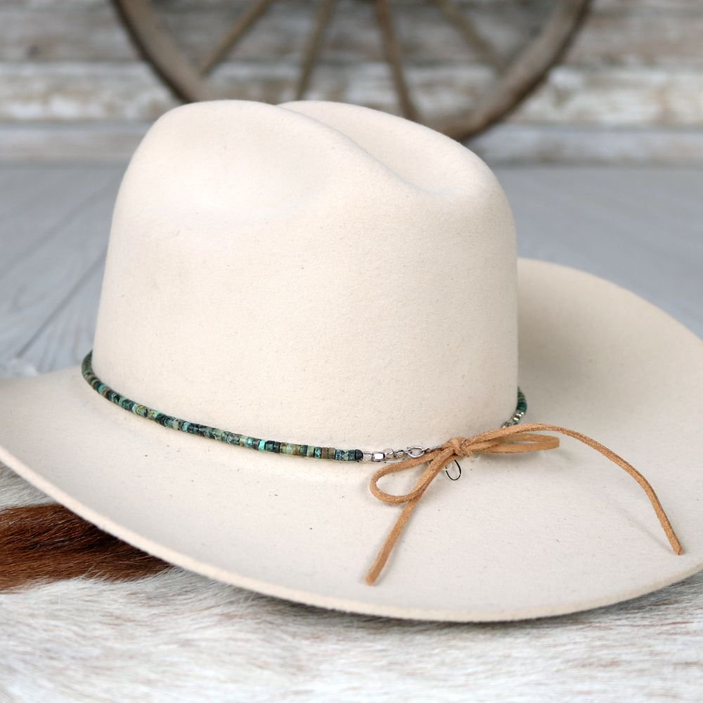 White felt cowboy hat with turquoise beaded hat band and tan ties