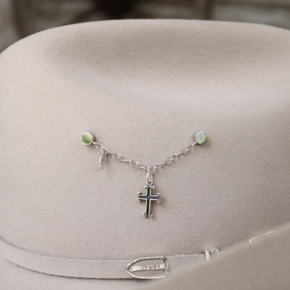 Sterling silver cross charm on delicate chain necklace with small green bead accents