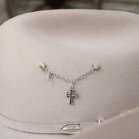 Sterling silver cross charm on delicate chain necklace with small green bead accents