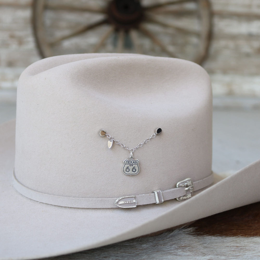 Sterling silver Texas Route 66 shield charm on chain on cowboy hat brim