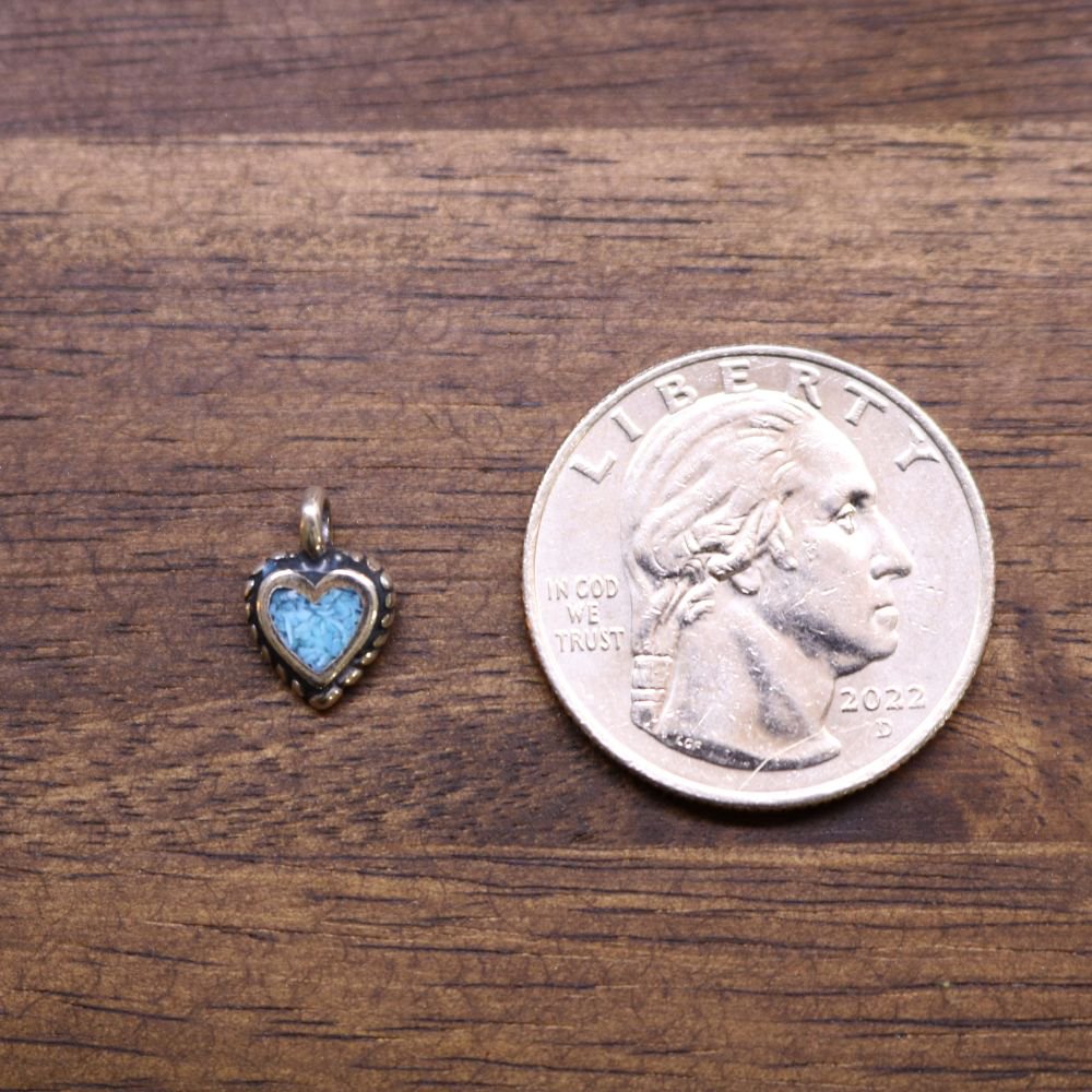 Heart-shaped metal charm with light blue inlay and top loop bail