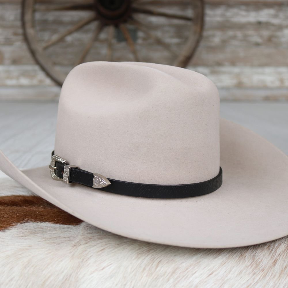 Tan cowboy hat featuring black leather band with silver buckle detail