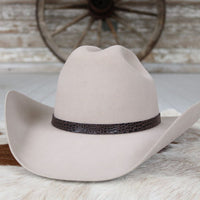 Light-colored cowboy hat with dark brown croc-pattern leather band