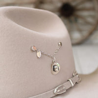 Sterling silver cowboy hat charm on a thin chain necklace with small accents.