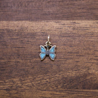 Sterling silver butterfly charm with blue enamel wings and top loop bail