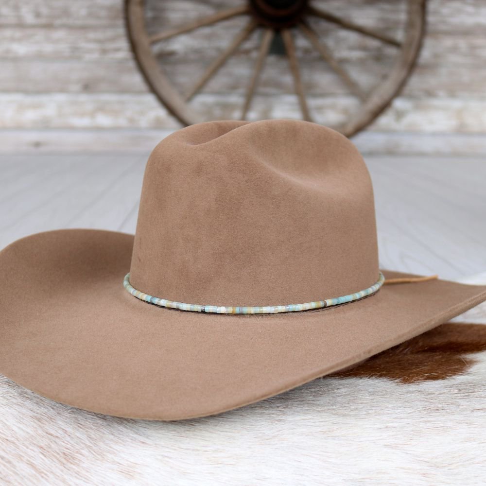 Brown wide-brim hat with turquoise beaded band centered across the brim