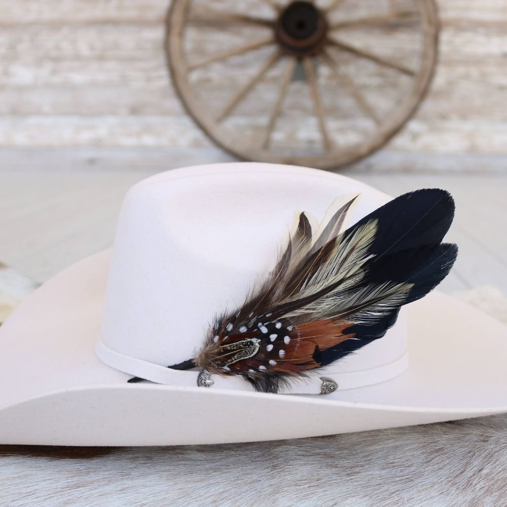 White felt hat with side feather accent and silver buckle detail