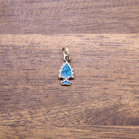 Turquoise inlay arrowhead charm with silver bail, blue drop design