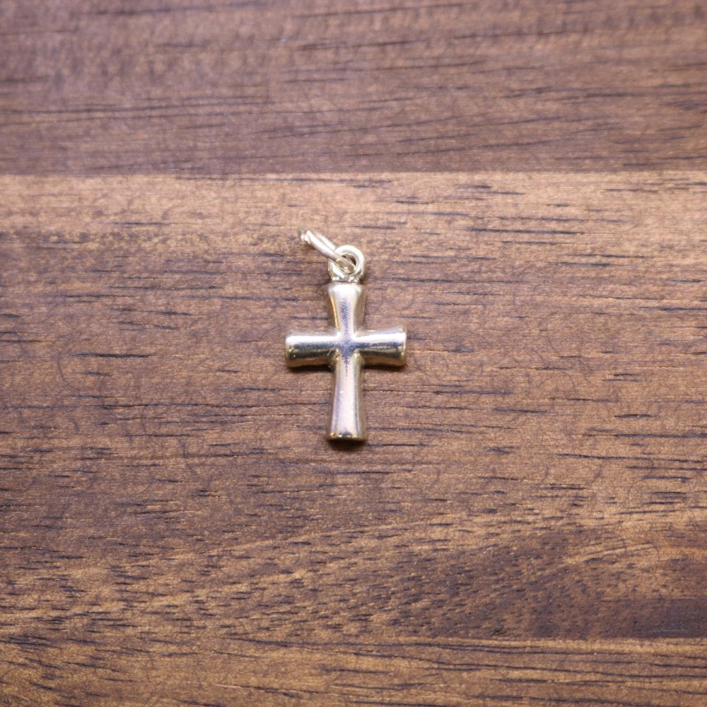 Sterling silver cross charm with small loop bail, polished finish.