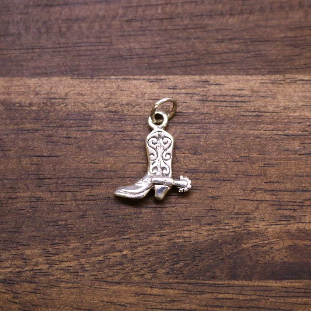 Sterling silver boot charm with decorative cutouts and loop bail